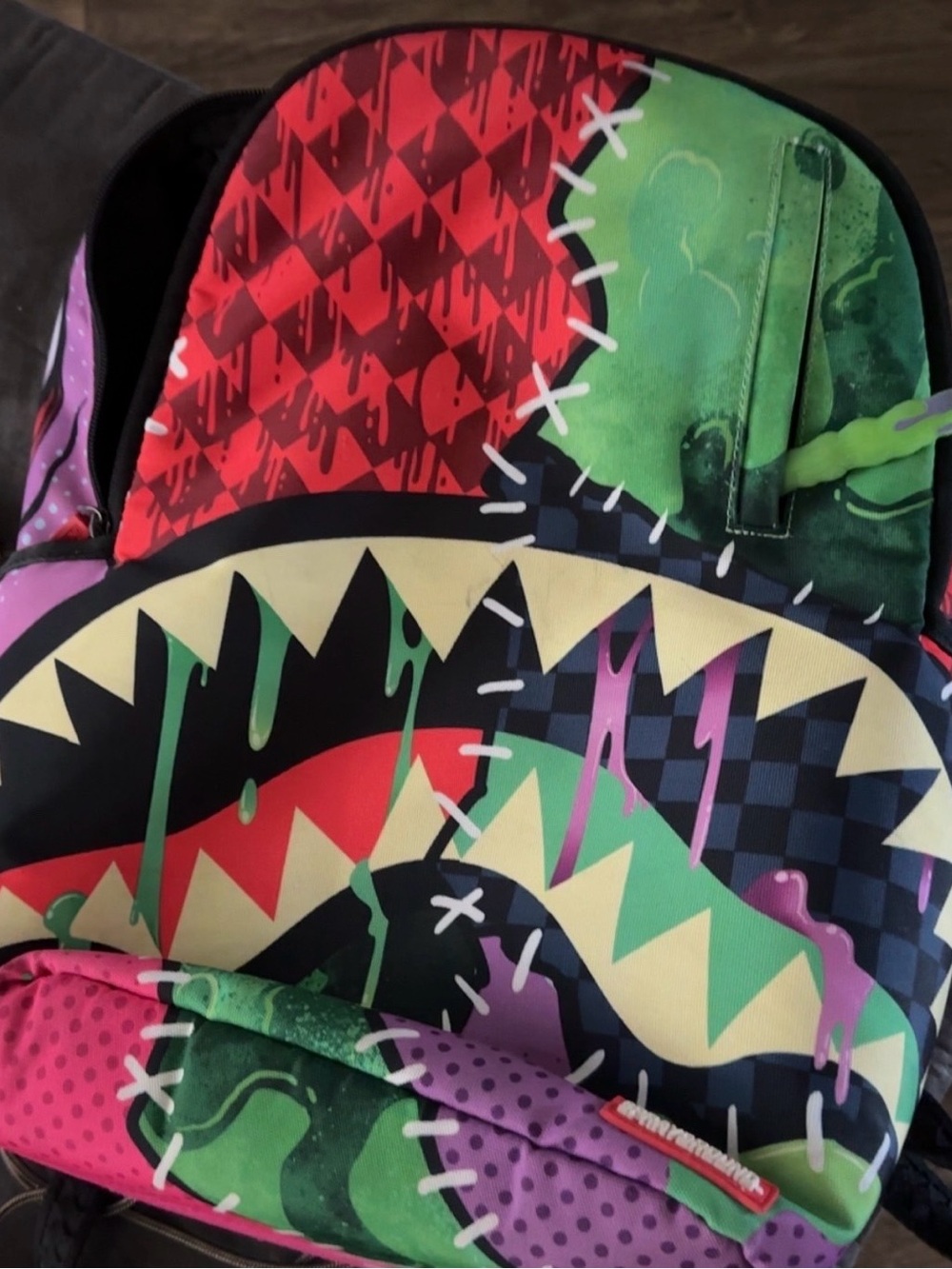 Vibrant Sprayground Graphic Shark Backpack in Red, Green & Purple
